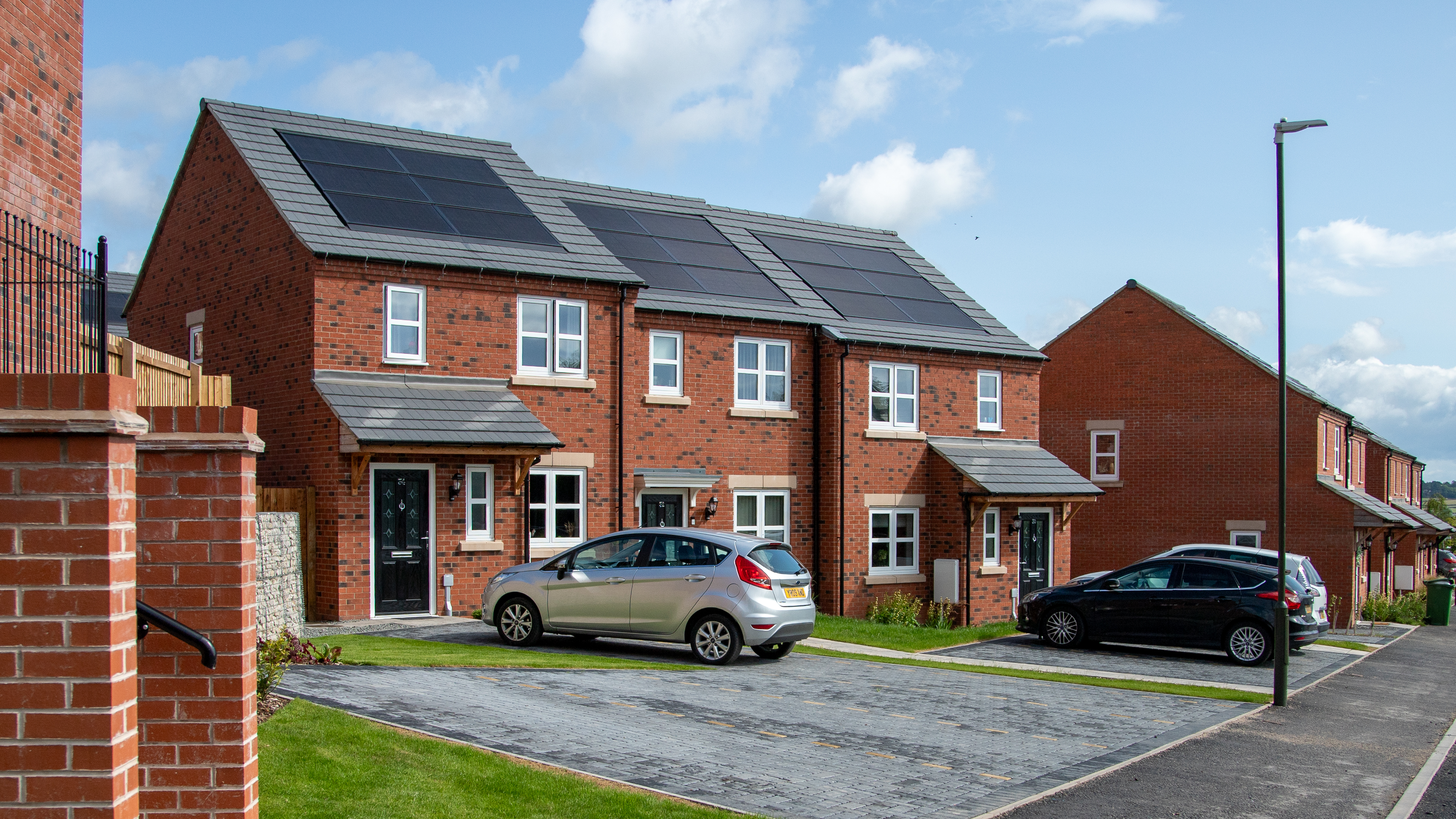 Row of three houses with solar panels on top
