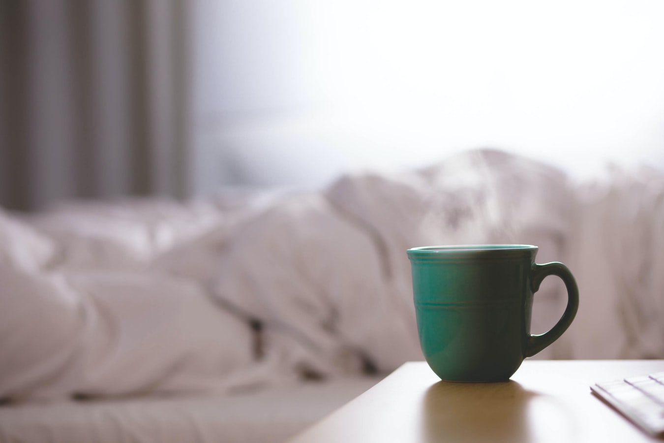 A steaming green mug