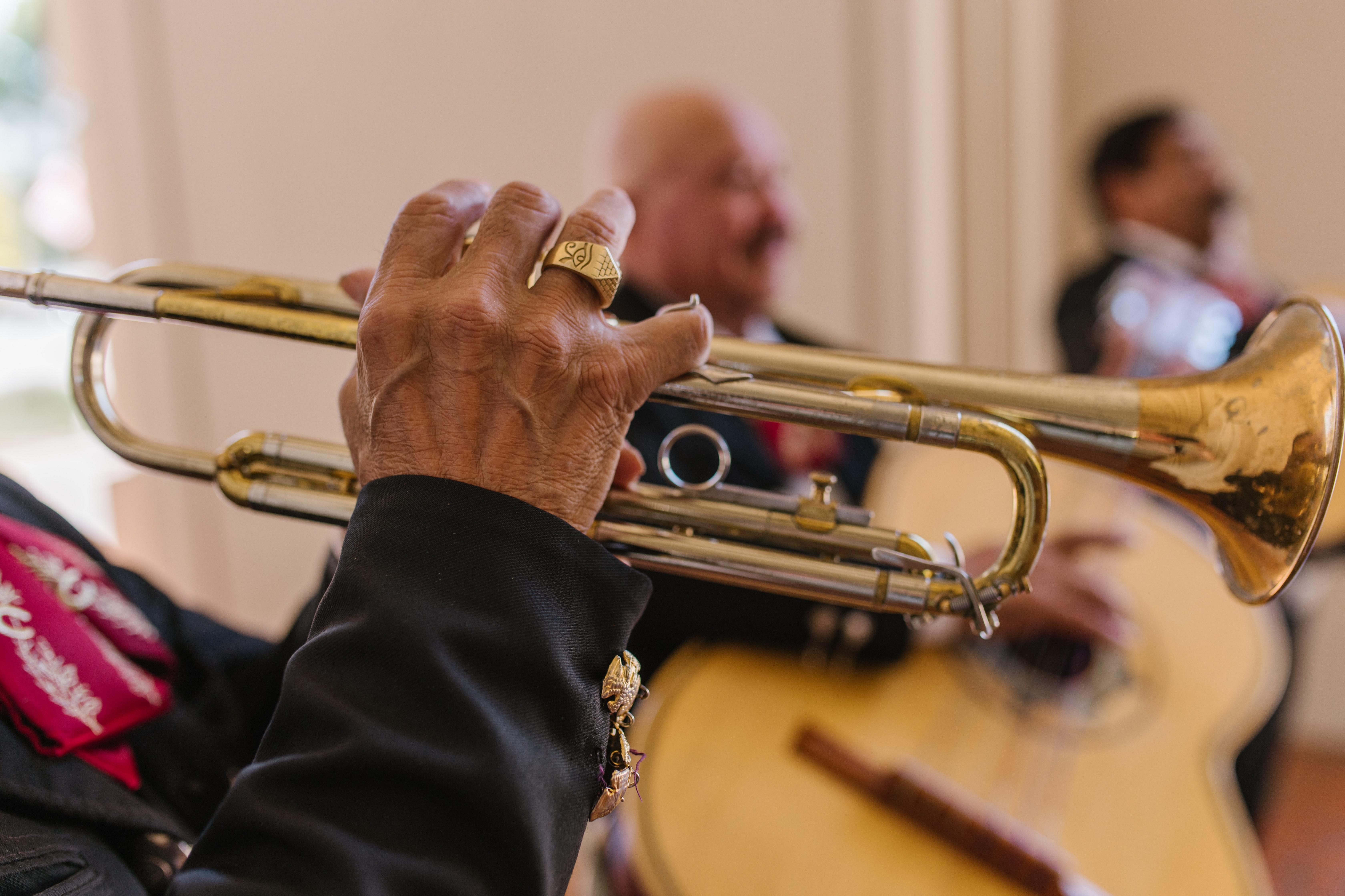 A man in a black shirt playing the trumpet.