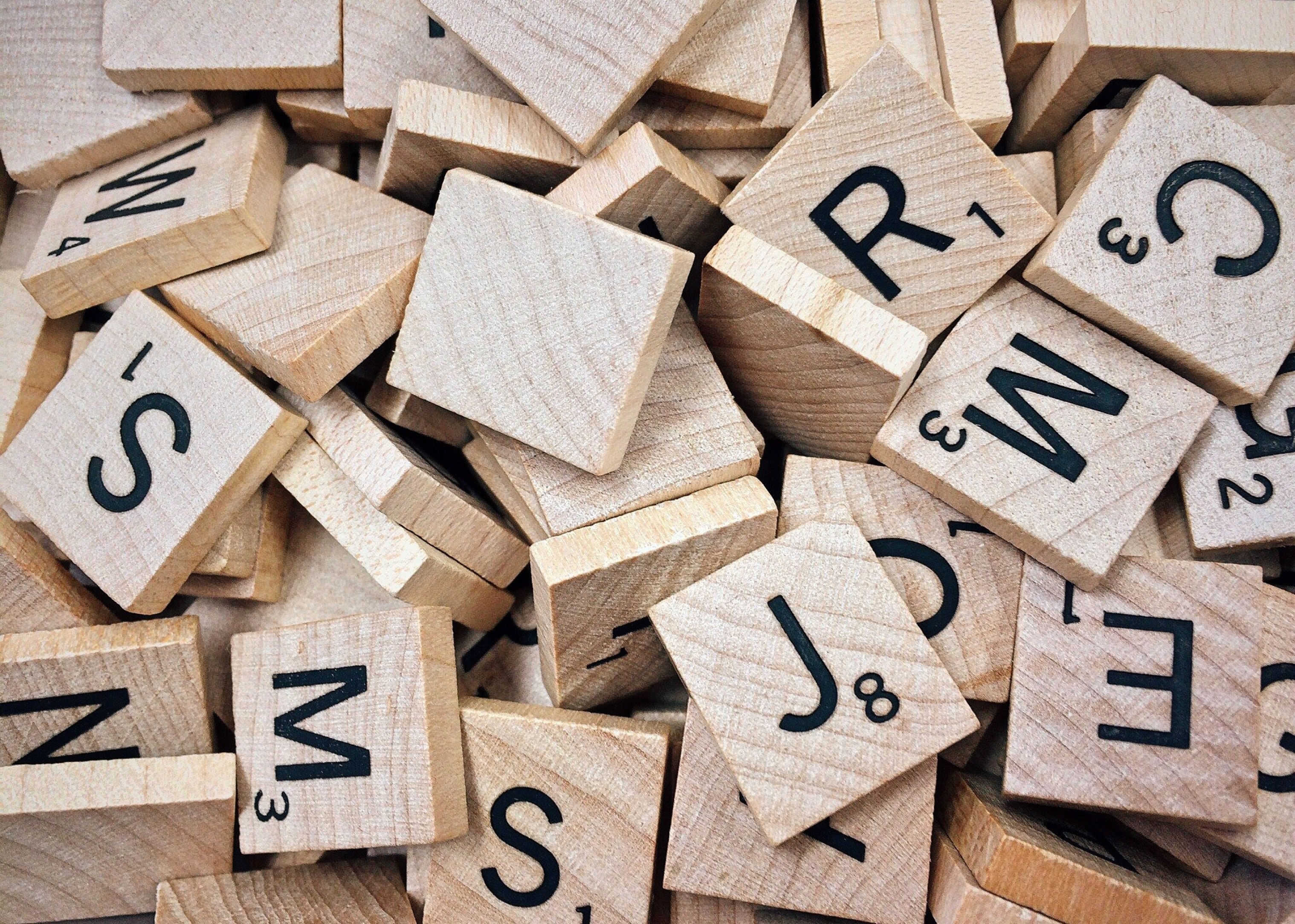 A pile of mixed scrabble tiles