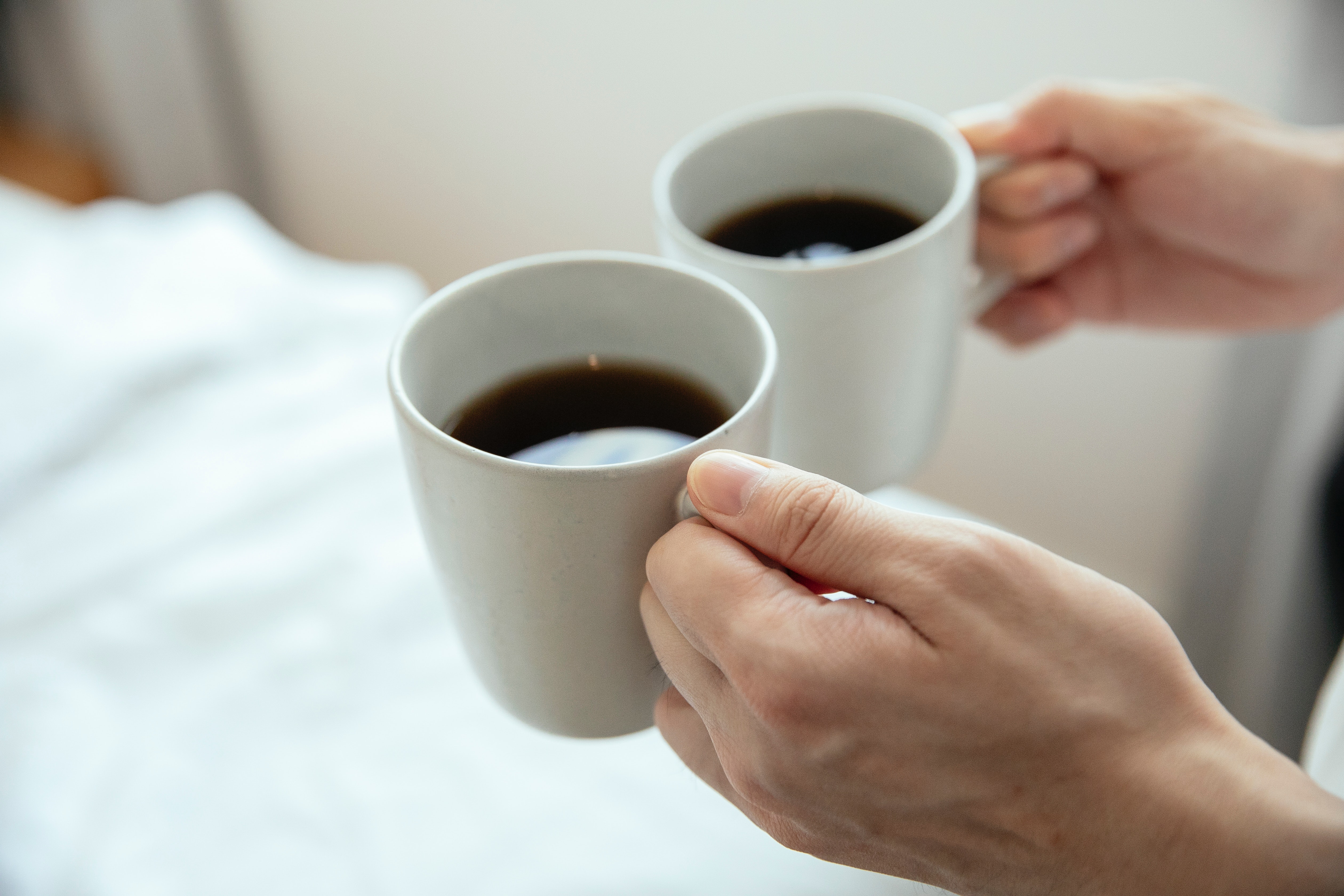 Someone carrying two cups of coffee