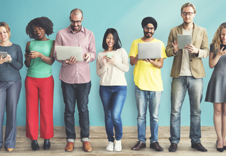 Photograph of a 'line-up' of people using laptops and mobiles