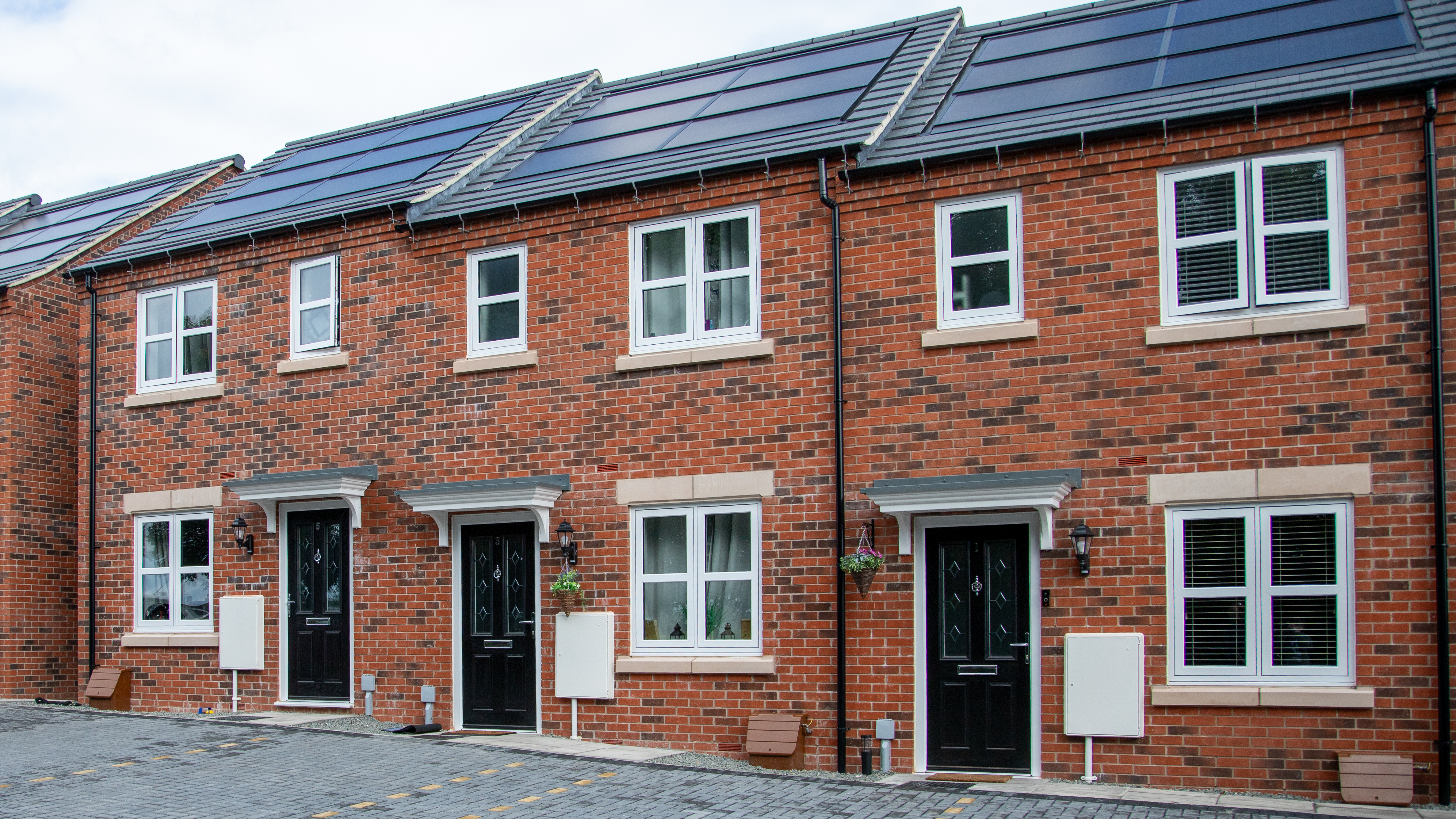 Row of terraced homes with solar panels on