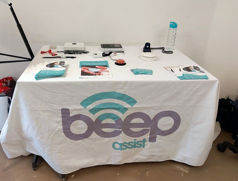 Photo of various products used by Beep Assist arranged on a display table.