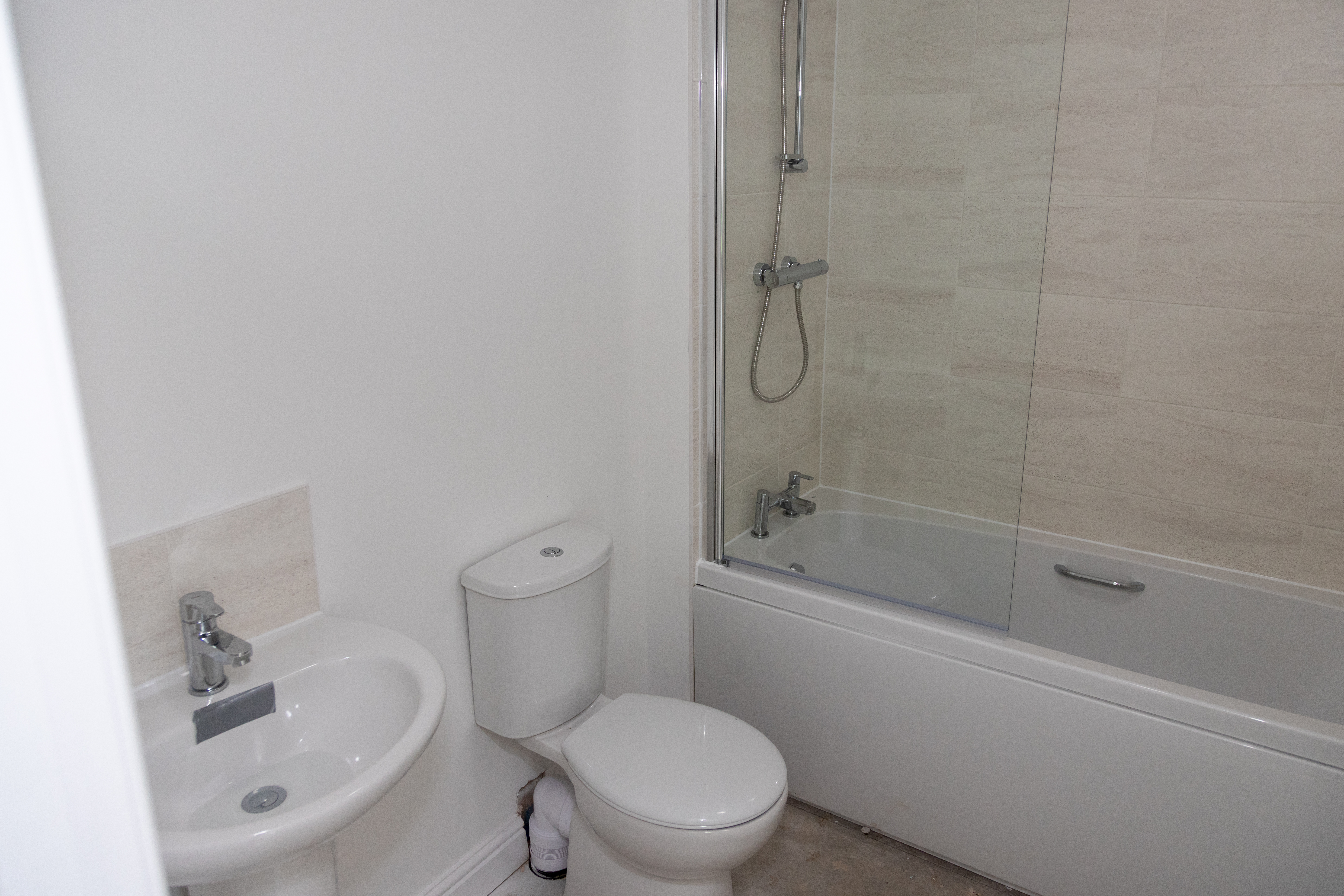 Photo of a sink, toilet and bath with shower