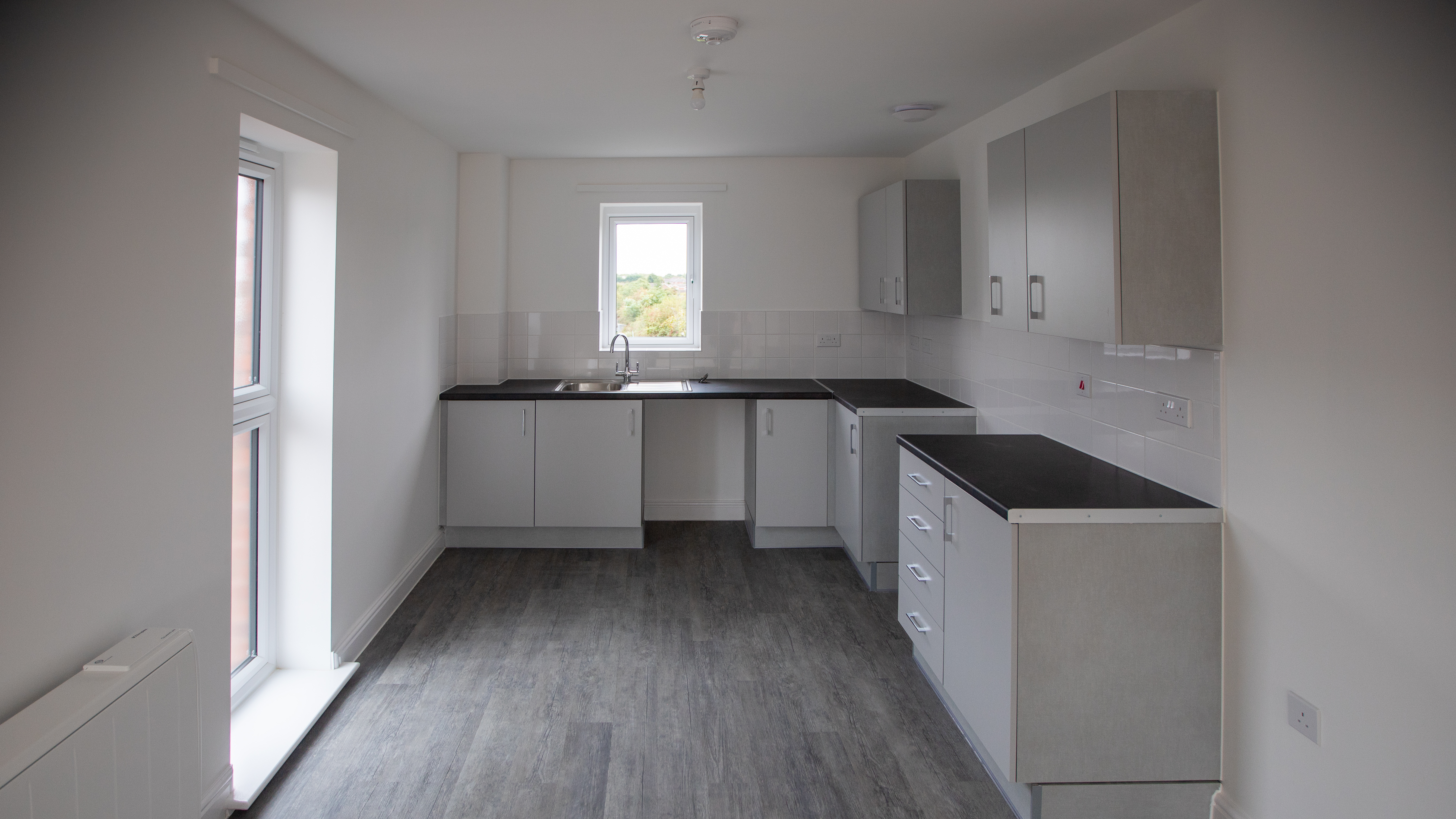 Modern white and grey kitchen in apartment
