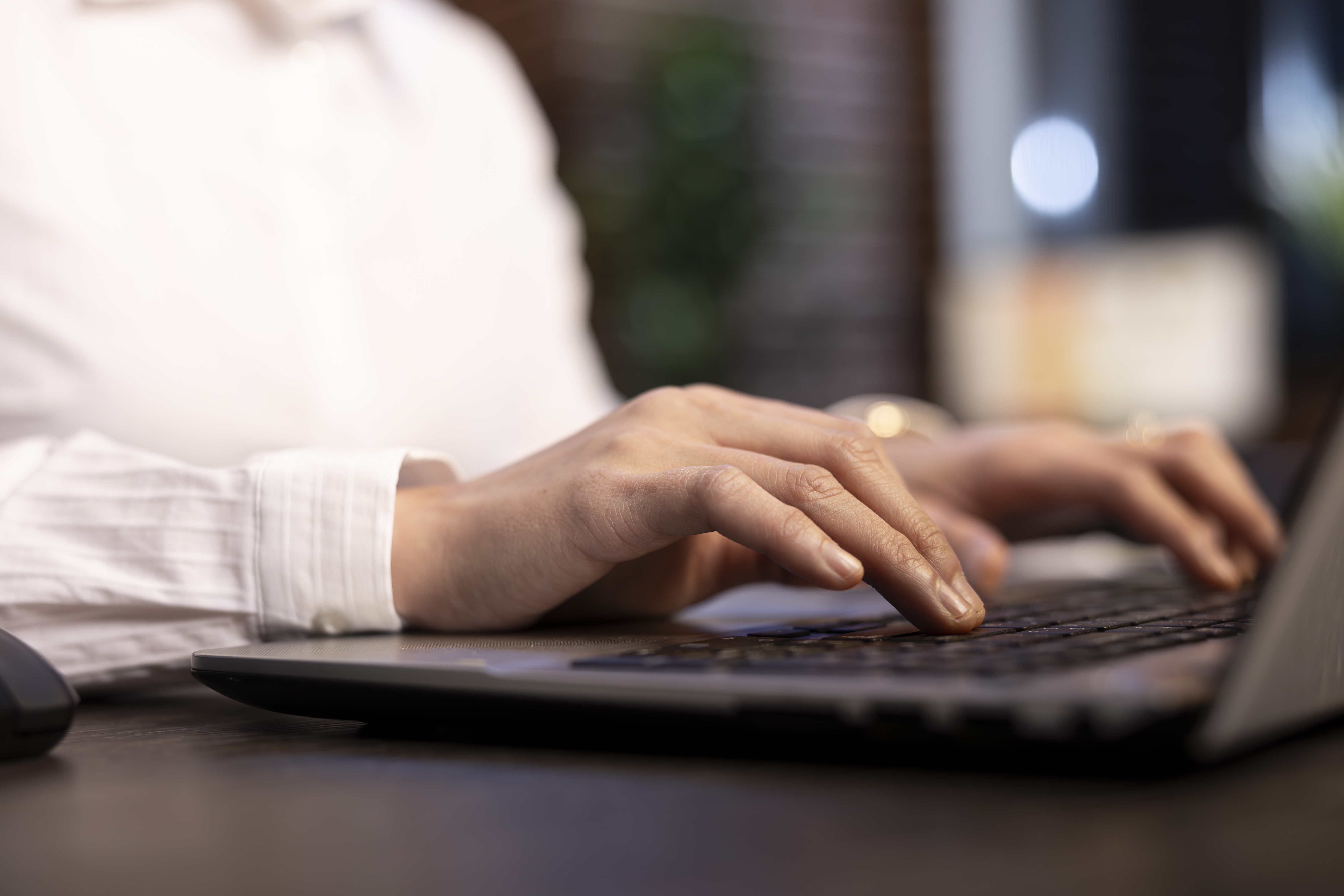 female employee typing with precision