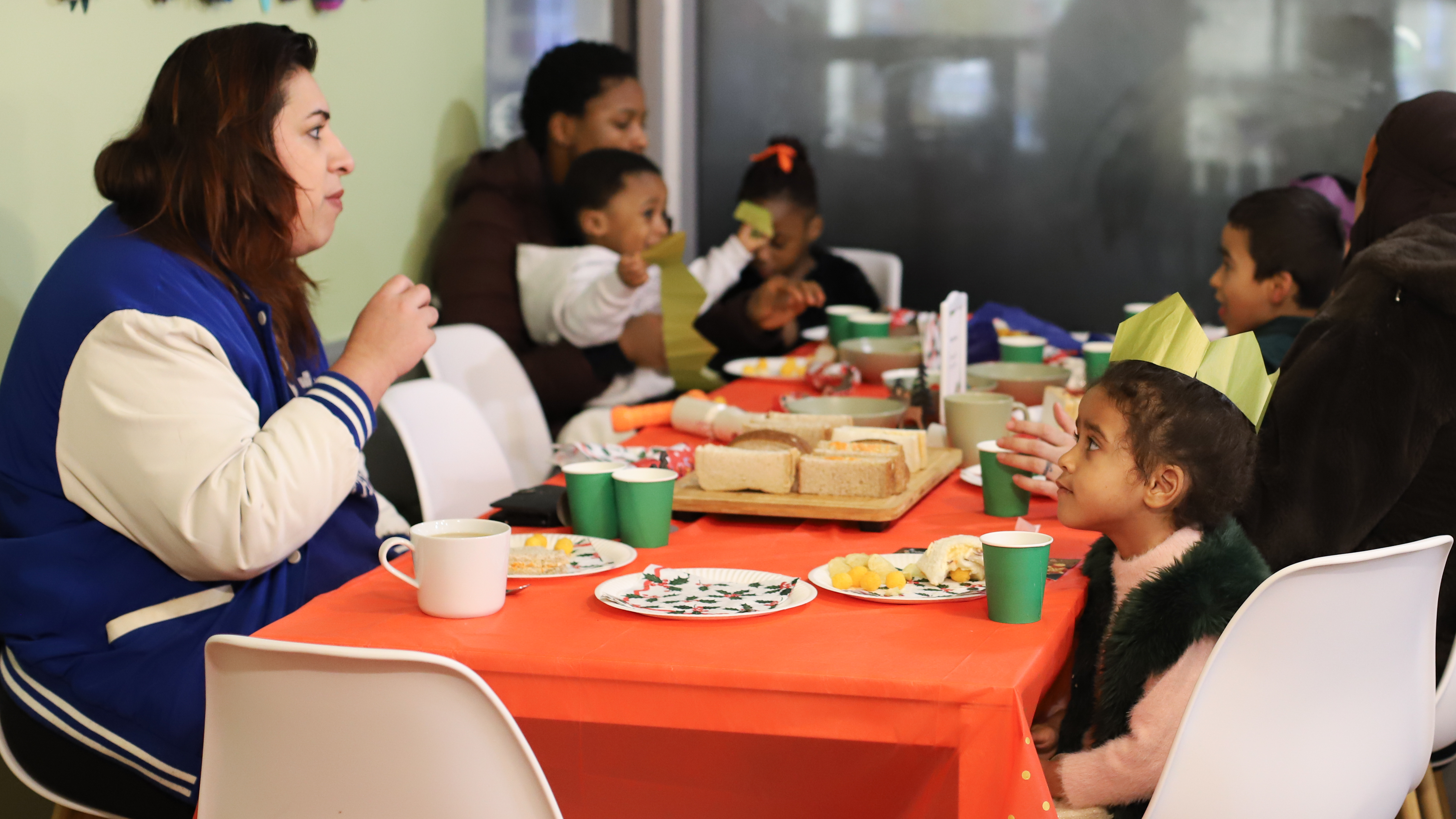 Photo of people sitting around a table with Christmas decorations on