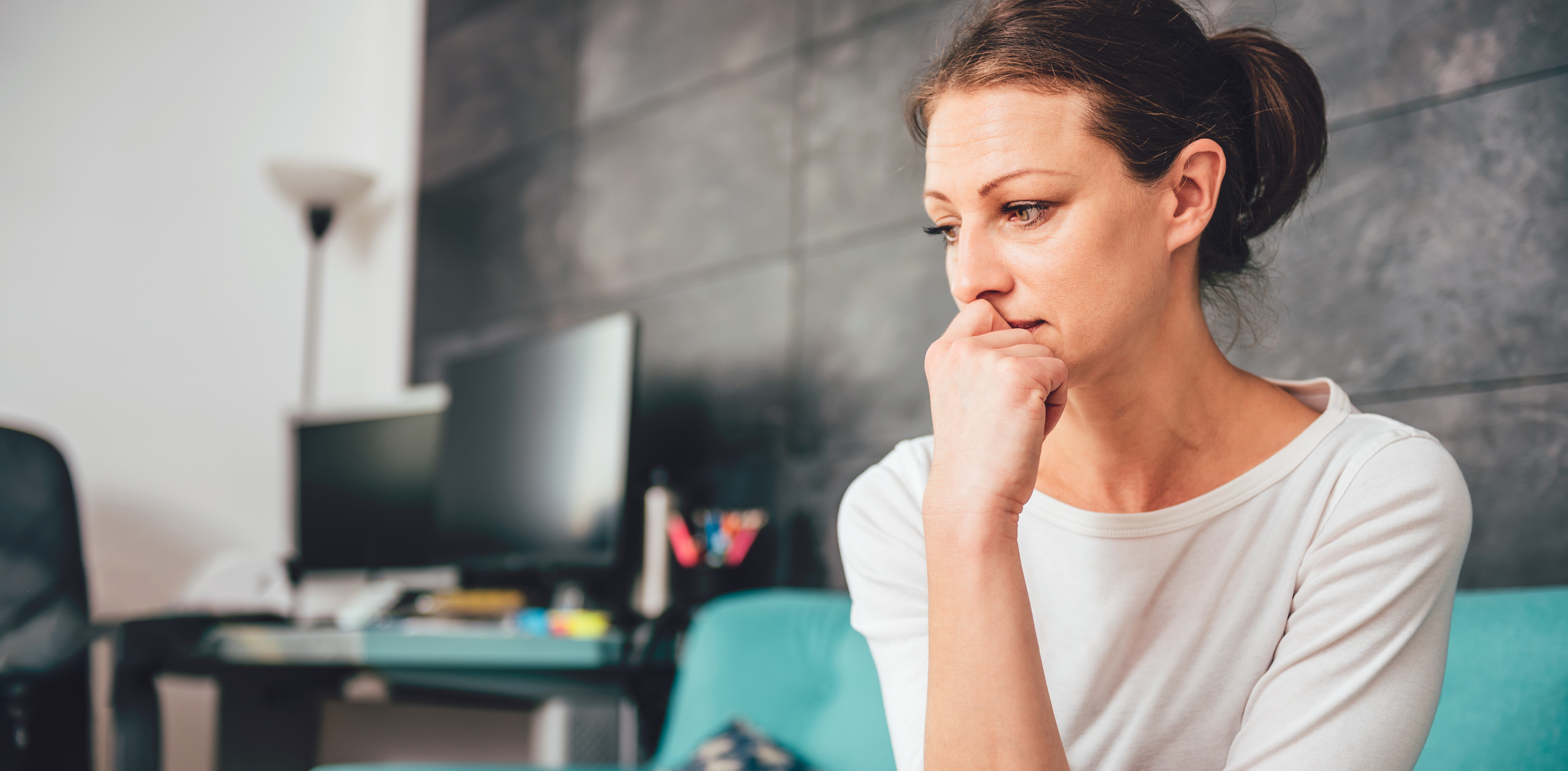 Sad Woman Sat On Sofa