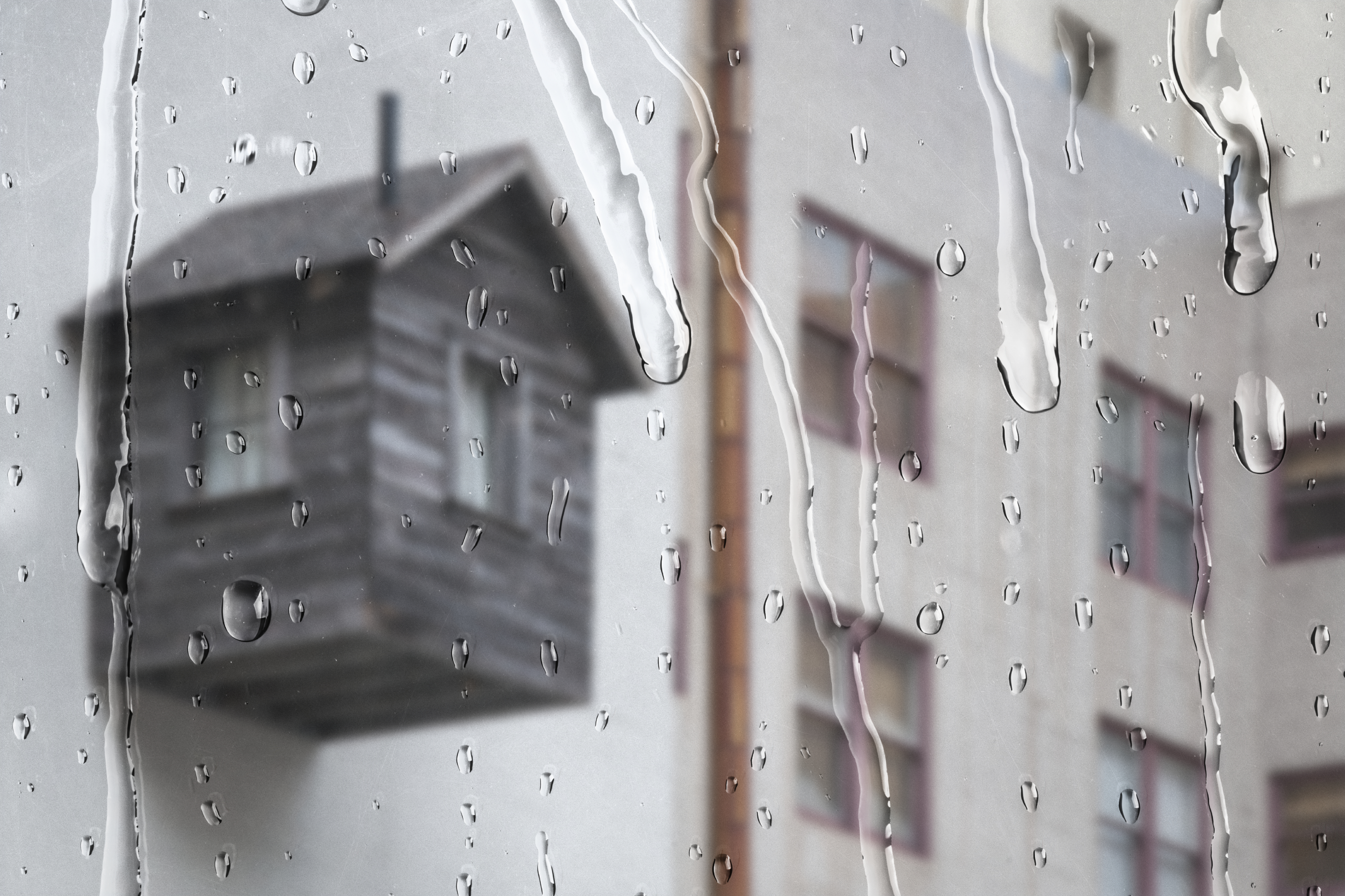 White Apartment Through Window With Rain Drops