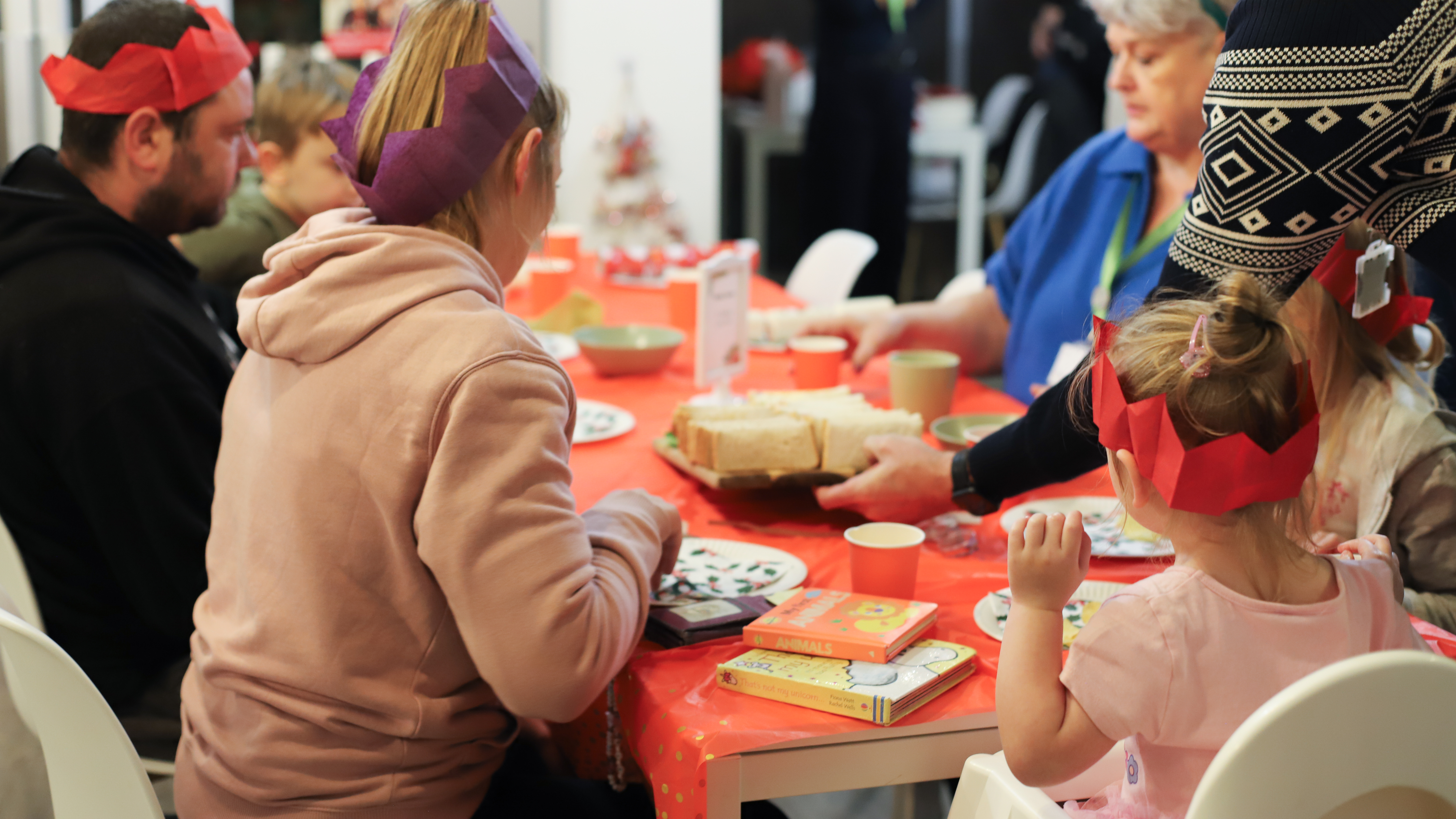 Photo of people sitting around a table with Christmas decorations on